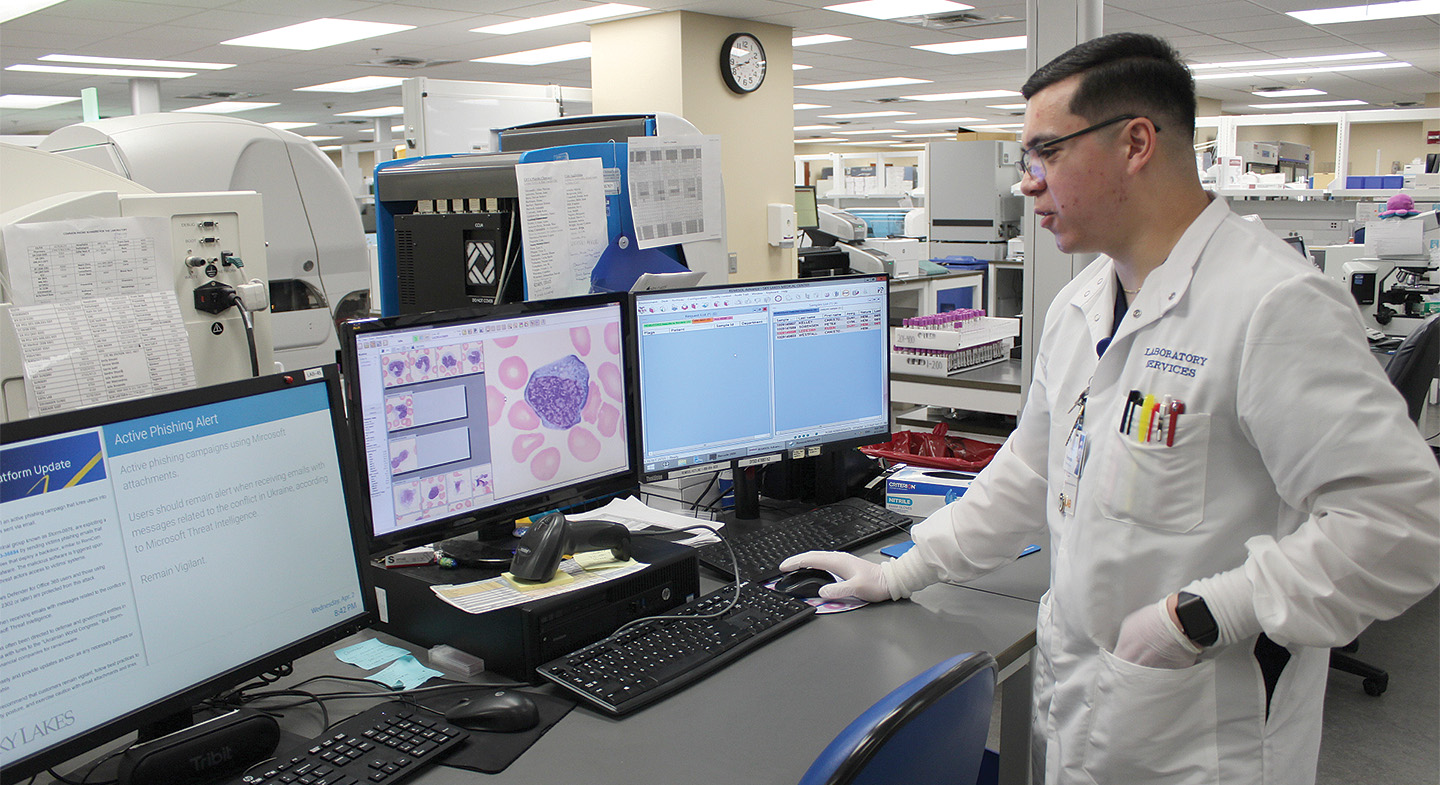 Fernando Torres, a lab technician at Sky Lakes Pathology Lab, looks for anomalies in blood samples as part of his work at the lab. A KCC graduate, Torres has worked at Sky Lakes for about two years.